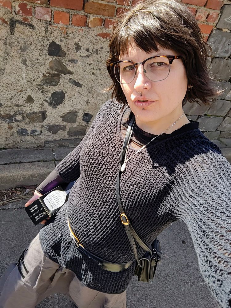 flat chested woman carrying a box of wine