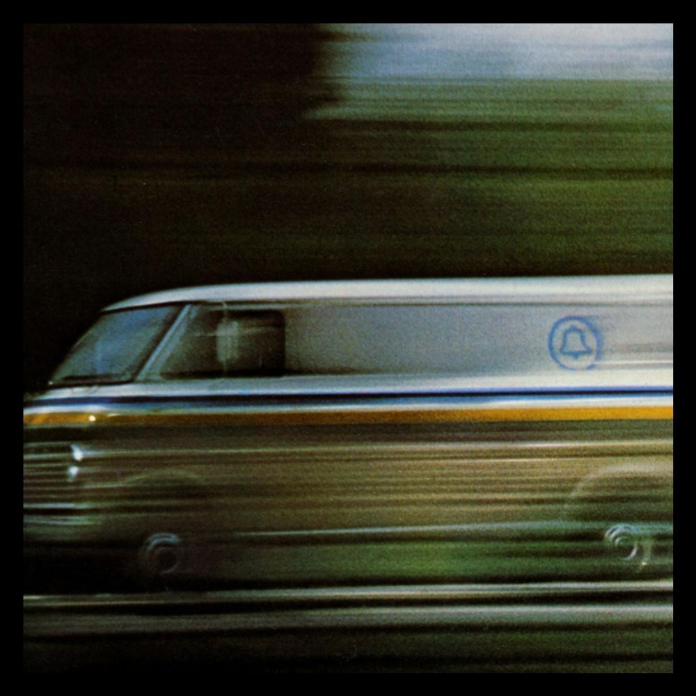 A speeding Bell telephone van with heavy motion blur. Very 1970s.