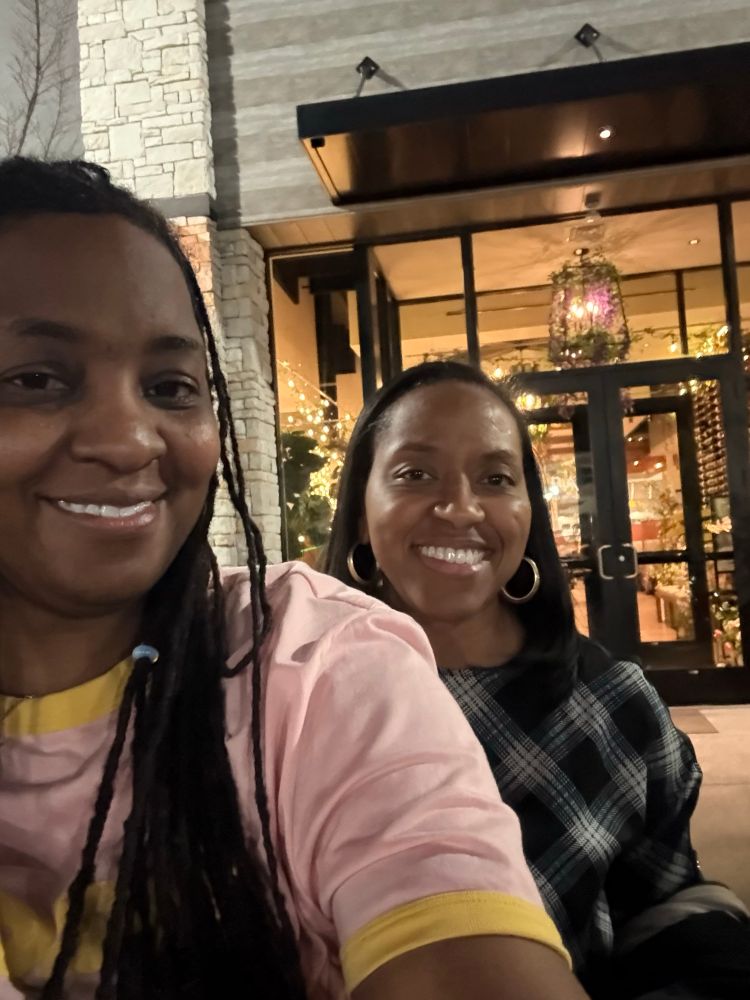 2 jovial people that look related. 
Left: Me, pink shirt with gold trims.
Right: Tiff, black and white blouse.