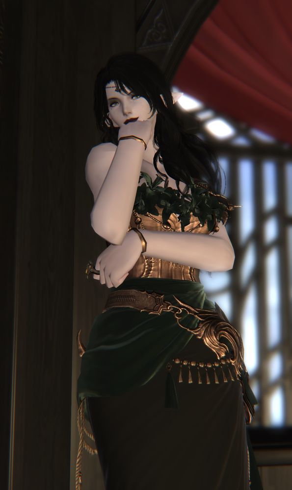 Abigail leans against post, clearly watching an amusing seen. She has one armed crossed in front of her while she partly hides her smile with other. 