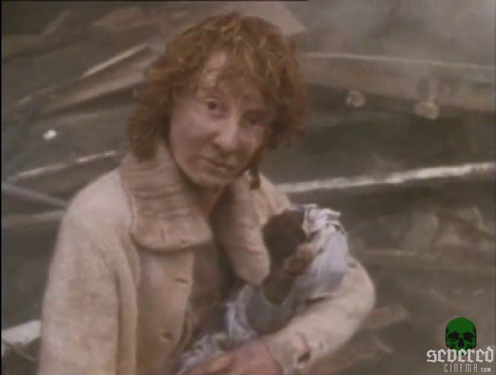 A lady cradling a charred dolly in Mick Jackson's romantic drama Threads