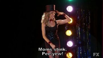 Dee from Always Sunny giving a musical performance singing “moms stink. Pee yew!”