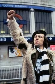 Robert Lindsay in a beret, with his fist raised, as Citizen Smith.
