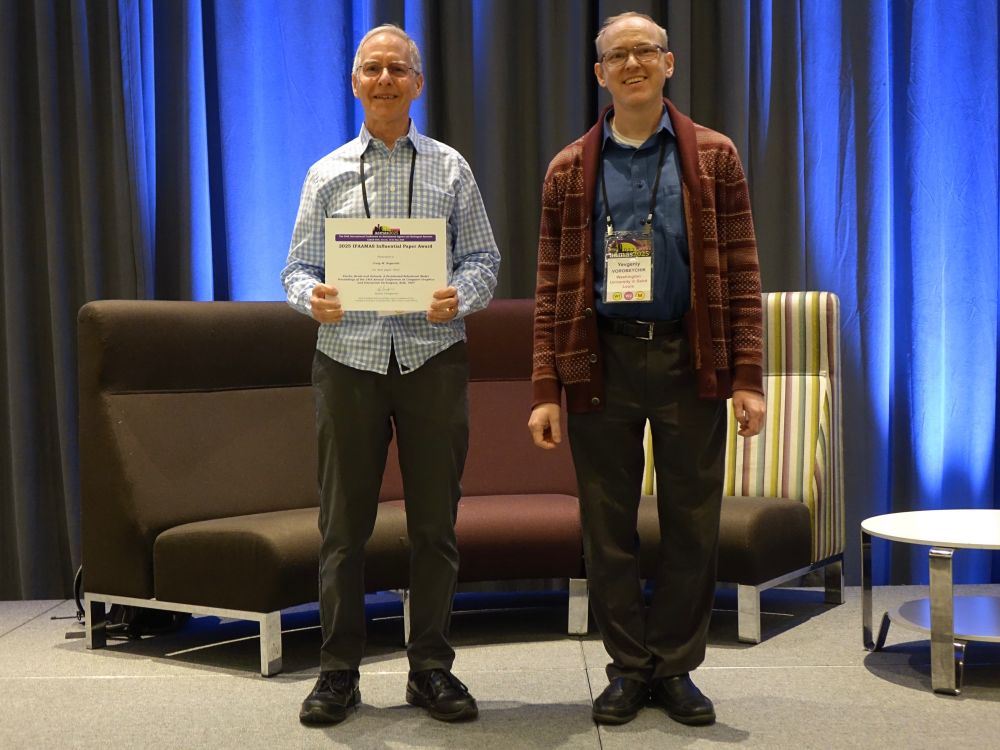 Craig Reynolds (left) having just received the 2025 IFAAMAS Influential Paper Award from Yevgeniy Vorobeychik at AAMAS 2025 in Detroit, Michigan, USA, on May 22, 2025.