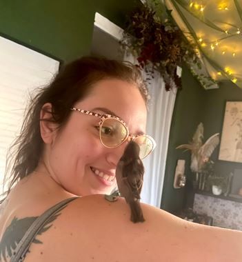 A photo similar to the last one, but nuggie has moved up to my shoulder and I tilted my head towards him. He is straining upward to inspect (aka peck at) my glasses.