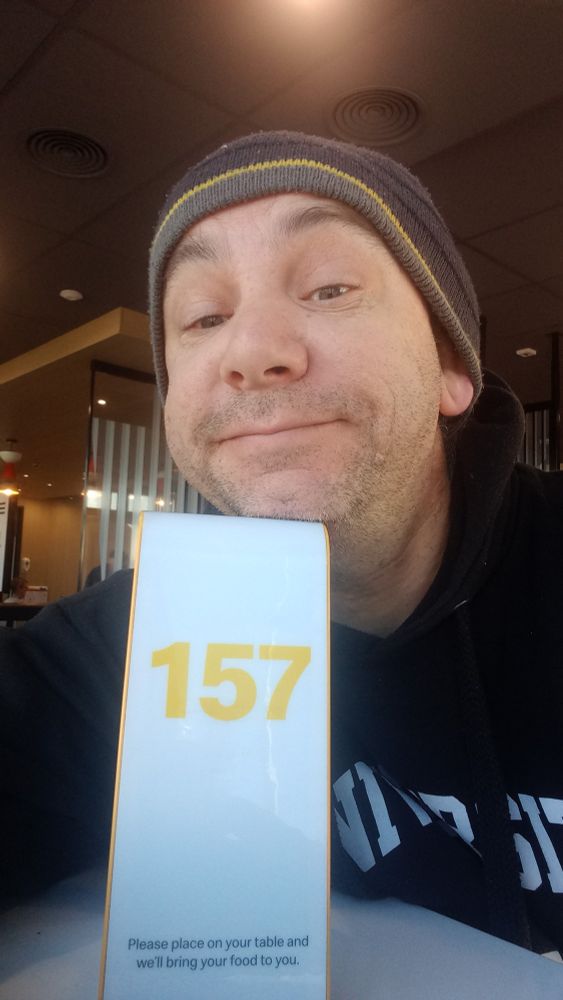 Wearing a beanie to cover the lack of hair, I sit with the number 157 at McDonald's waiting for my food. 