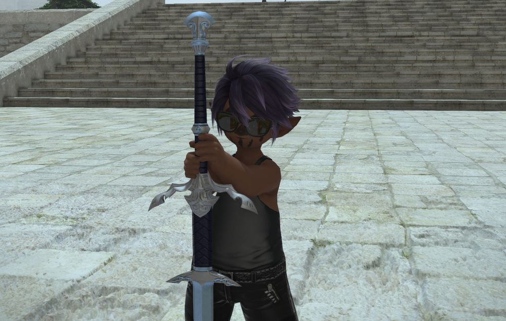 A screen-cap from Final Fantasy XIV: Dawntrail featuring my character - the Lalafell Dark Knight Sandy Doomsparkles - posing with her zweihander sword in the plaza of Limsa Lominsa. Sandy is wearing dark sunglasses, a black tank top, black leather pants, and black boots. She has face-paint in the shape of a skull on her face. She is cosplaying as Gideon the Ninth from the Locked Tomb trilogy by Tamsyn Muir.