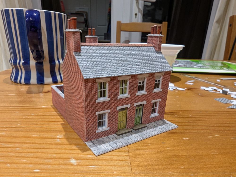 Front view of cardboard model of terraced house, brick finish, in N scale. 