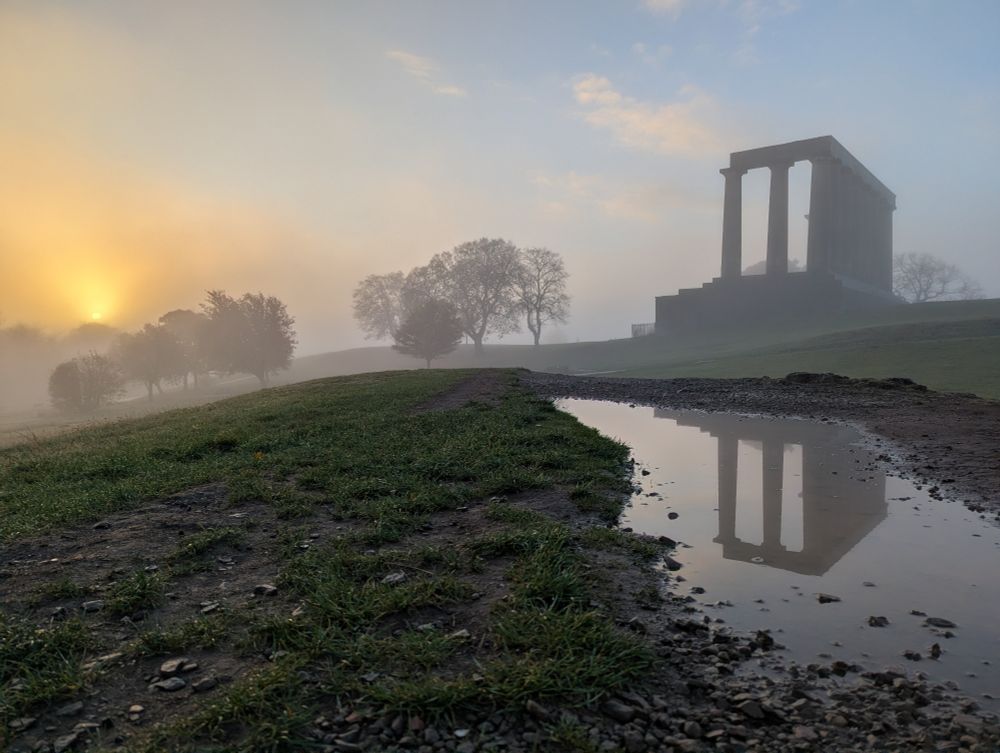 Sunrise through the fog on Calton Hill, Edinburgh.