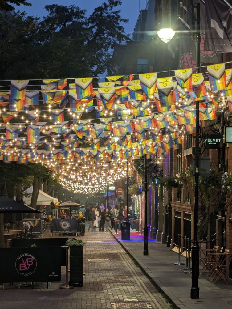 Canal Street, Manchester. Progress Pride flags and fairy lights make a tapestry of colour.