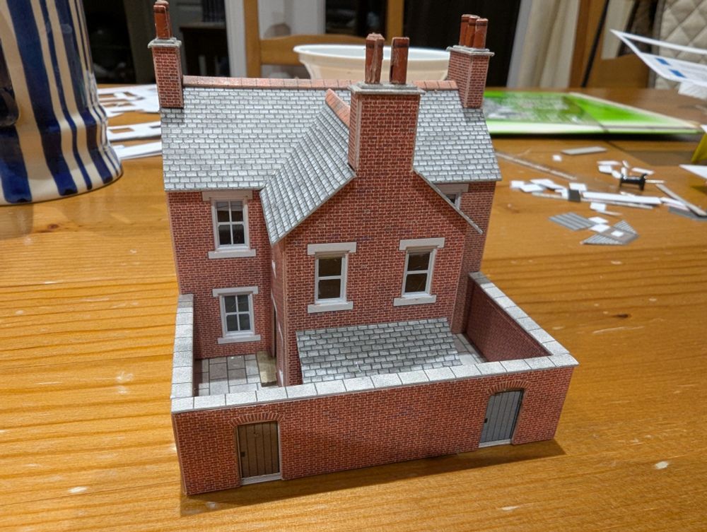 Rear view of cardboard model of terraced house, brick finish, in N scale. 