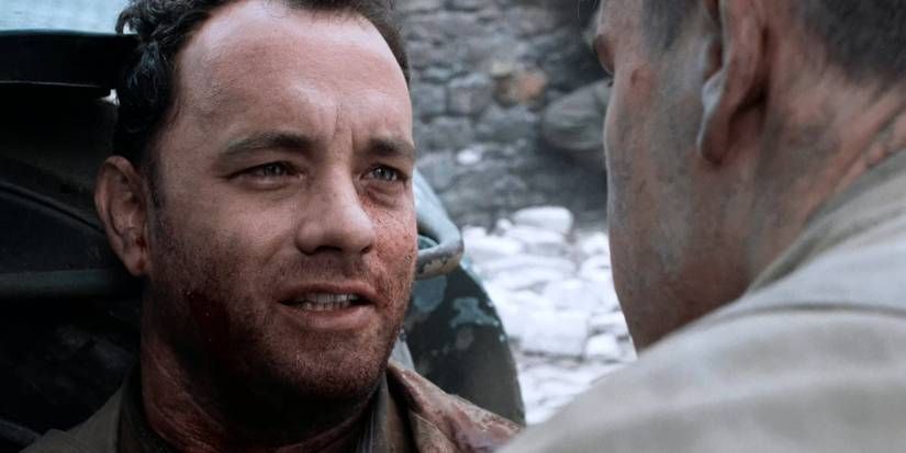 Tom Hanks and Matt Damon in the "earn this... earn it." scene from Saving Private Ryan.  Hanks is seated, dying, his back against the front of a jeep.  Damon is leaning in to hear what he has to say.