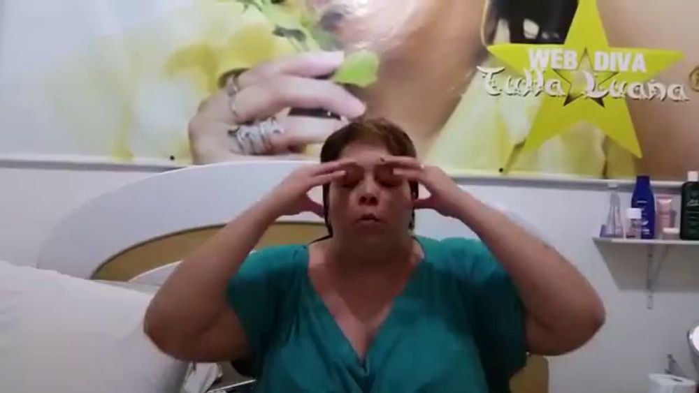 a woman covering her ears in front of a web diva poster