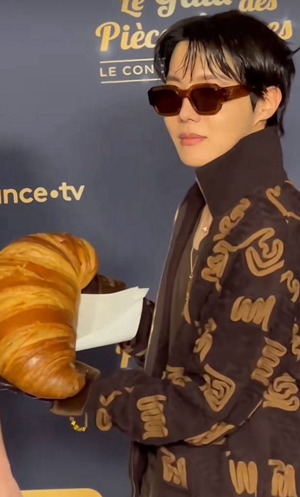 j-hope holding a big croissant
