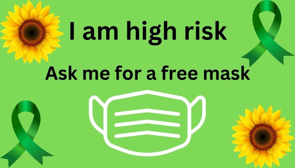 Green background. Yellow sunflowers in 2 corners, green ribbons in the other 2. Central is a white illustration of a face mask with text "I am high risk ask me for a free mask"