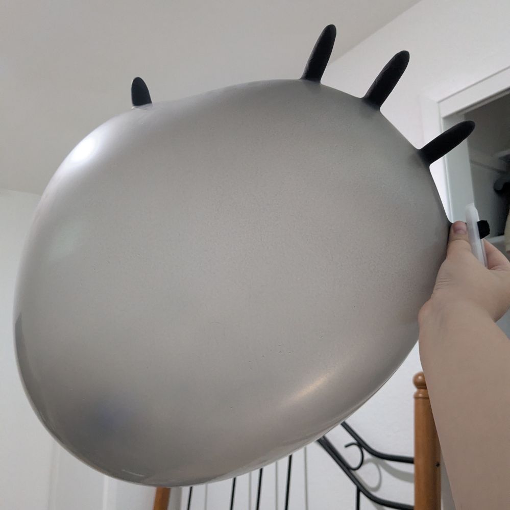 A black latex glove filled with air.