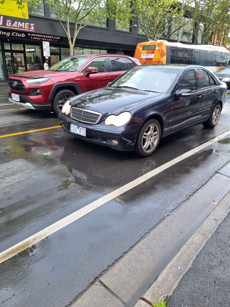 Dark car on a road in the rain 