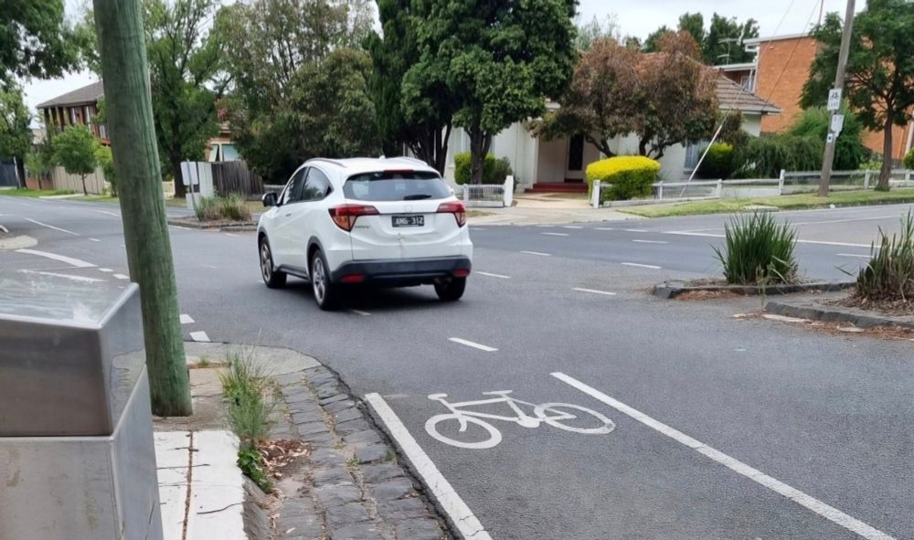 Another car driver cutting dangerously into an unprotected bike lane