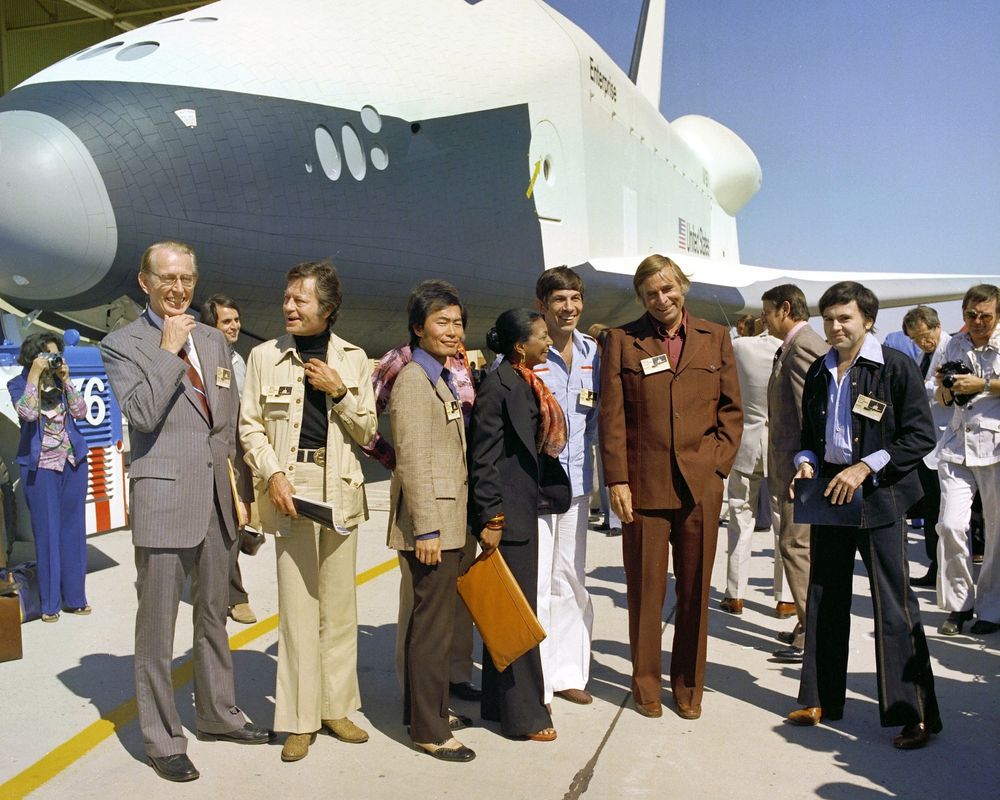 https://www.nasa.gov/history/45-years-ago-space-shuttle-enterprise-arrives-at-nasas-kennedy-space-center/ cast of the original Star Trek series gathers in front of the real Space Shuttle Enterprise September 17, 1976