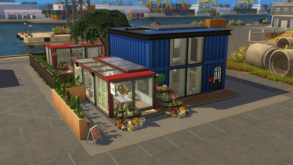 Axonometric view of red and blue shipping containers that make up a florist, a house and a greenhouse 