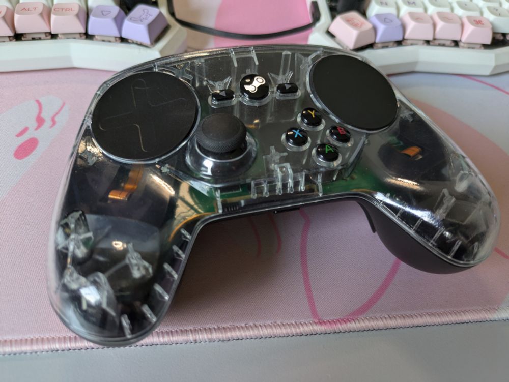A picture of a steam controller with a transparent front shell.