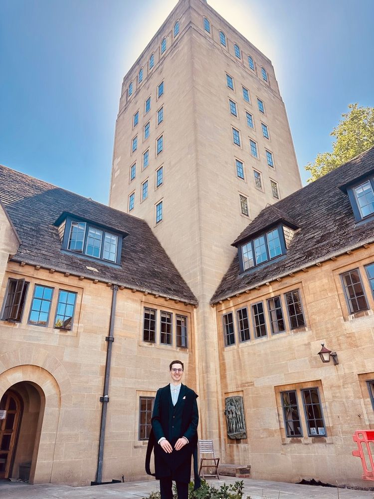 Student in front of tower at Nuffield College