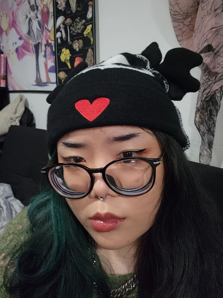 femme with skelanimal hat pouting . Also with glasses. 