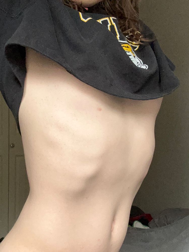 I'm wearing just a cropped hoodie and I'm stretching up to where you can see a little bit of titty but just not quite see any nipple