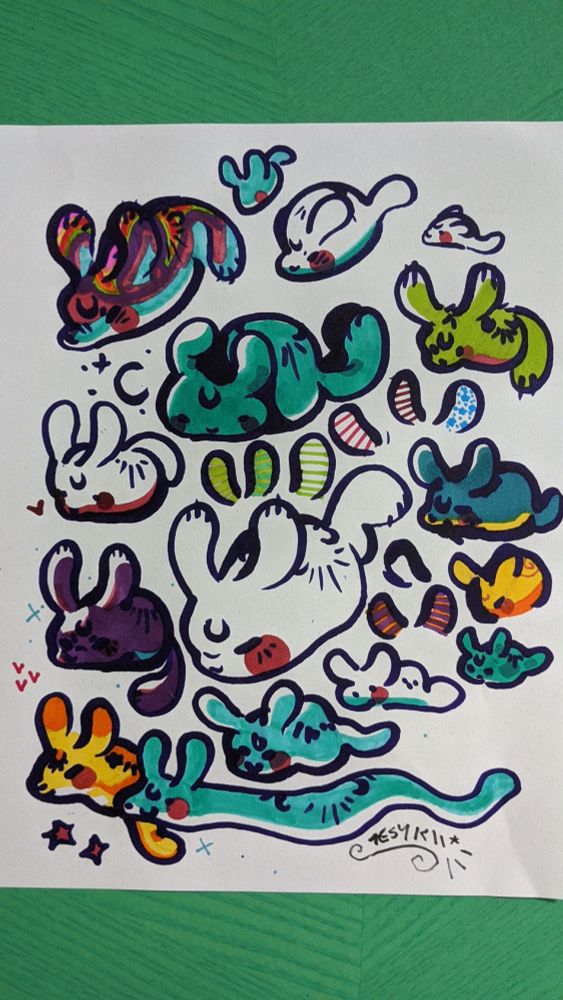 a traditional marker drawing page of a bunch of sea bunny like characters in a bunch of different colours.