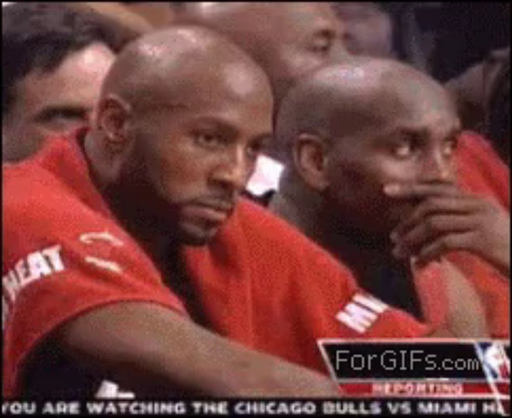 a group of men are watching a chicago bulls vs. miami heat game