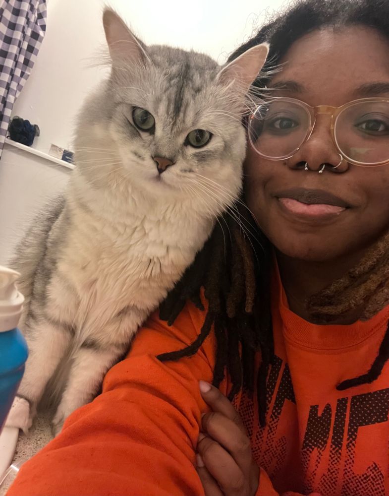 My cat Case (persian tabby mix) and me (OP) staring into the camera.