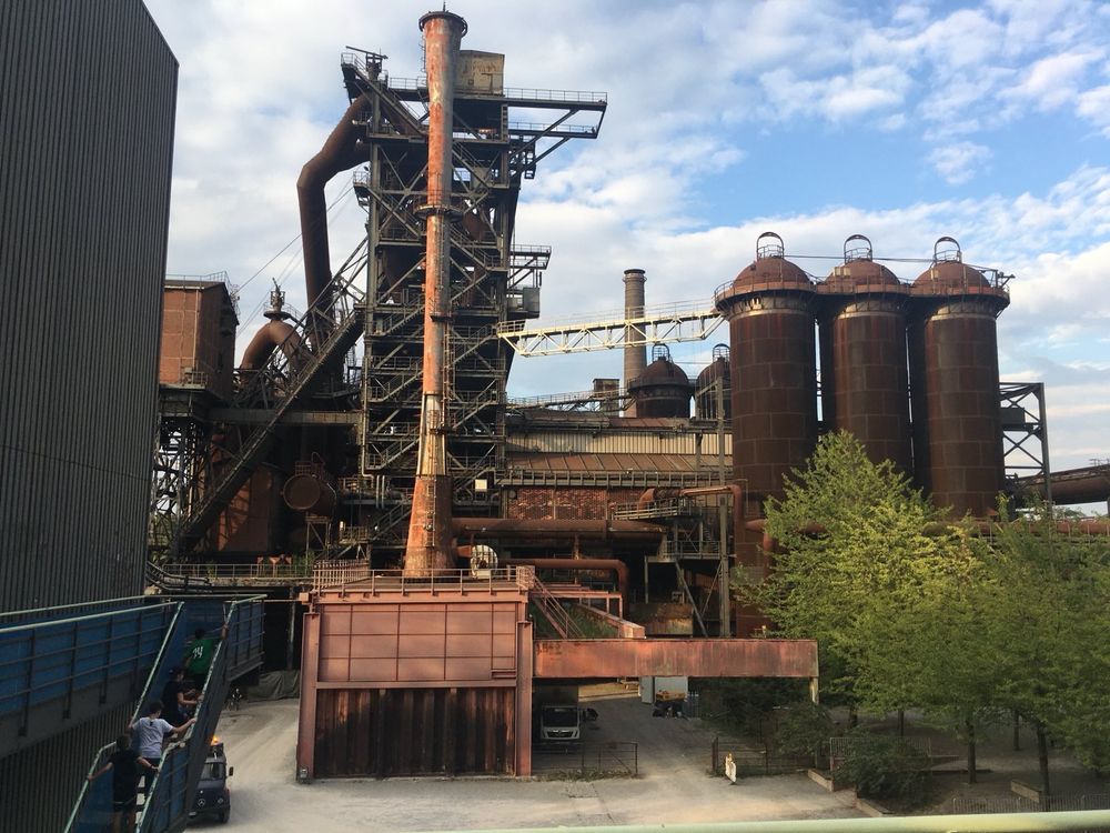 Picture shows part of the old steel mill in Duisburg Nord, now converted into a park, with a cluster of trees growing within the complex