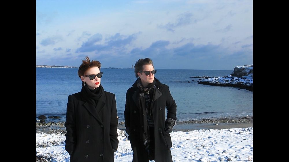 The band GHOST COP standing in front of a a snowy beach 