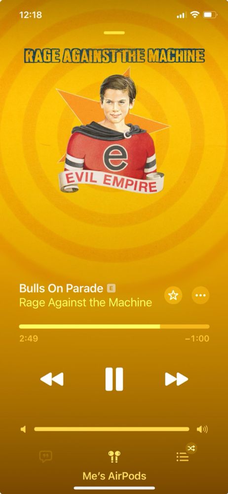 iTunes album cover for the band Rage Against the Machine (for the song Bulls On Parade) featuring a boy in a red shirt & a small ribbon banner at his chest that says “Evil Empire.” 
