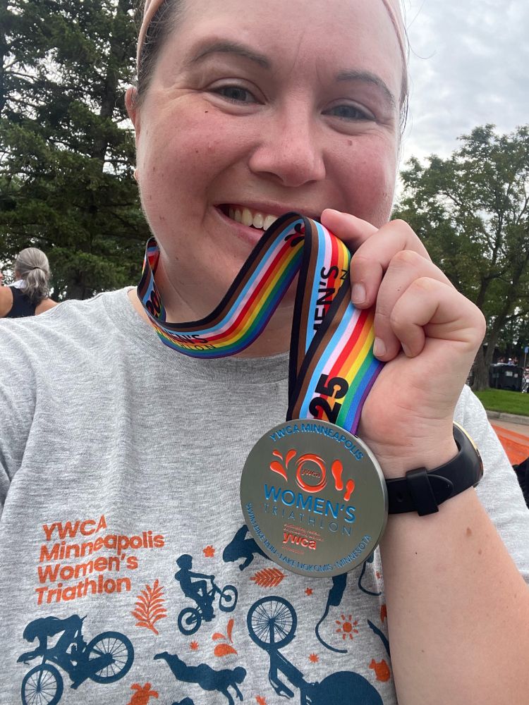 The user holding up her medal for the 2025 YWCA Minneapolis Women's Triathlon