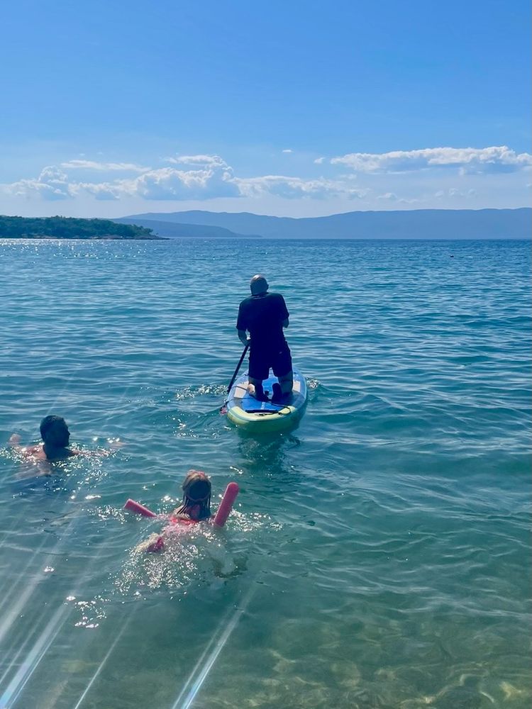 Zoran Jambor of CSS Weekly riding a SUP at sea.