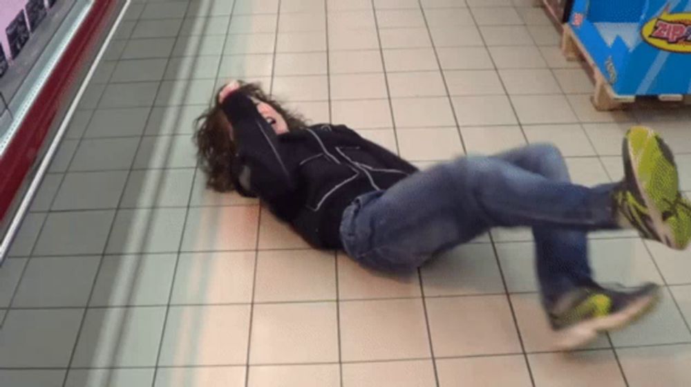 a person is laying on the floor in front of a display of zap