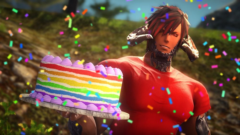 A 2024 birthday photo of Azazel in a red shirt, holding a large rainbow-colored cake with one hand, and winking at the viewer.