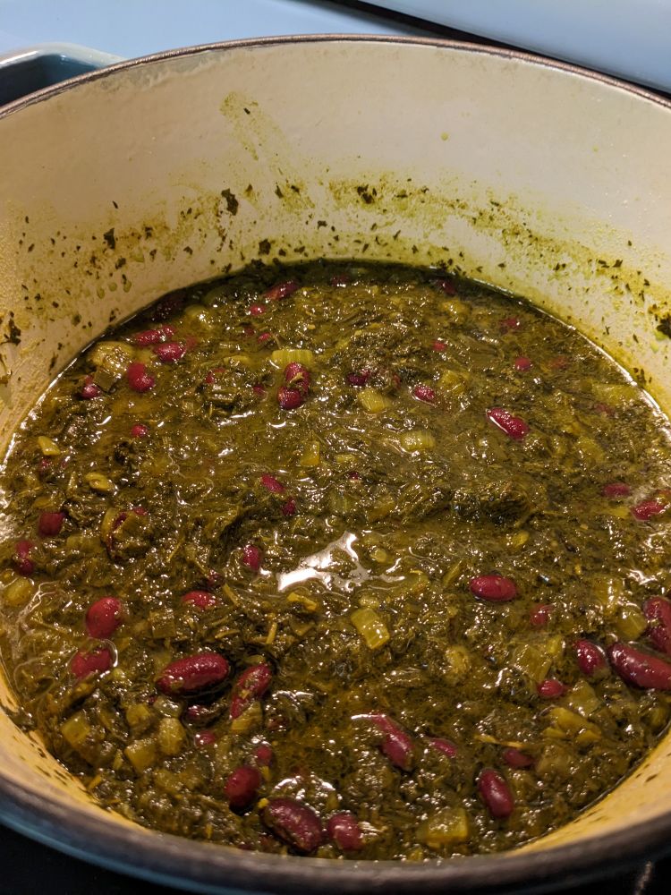 Finished ghormeh sabzi, an herb and bean stew, in a big Dutch oven