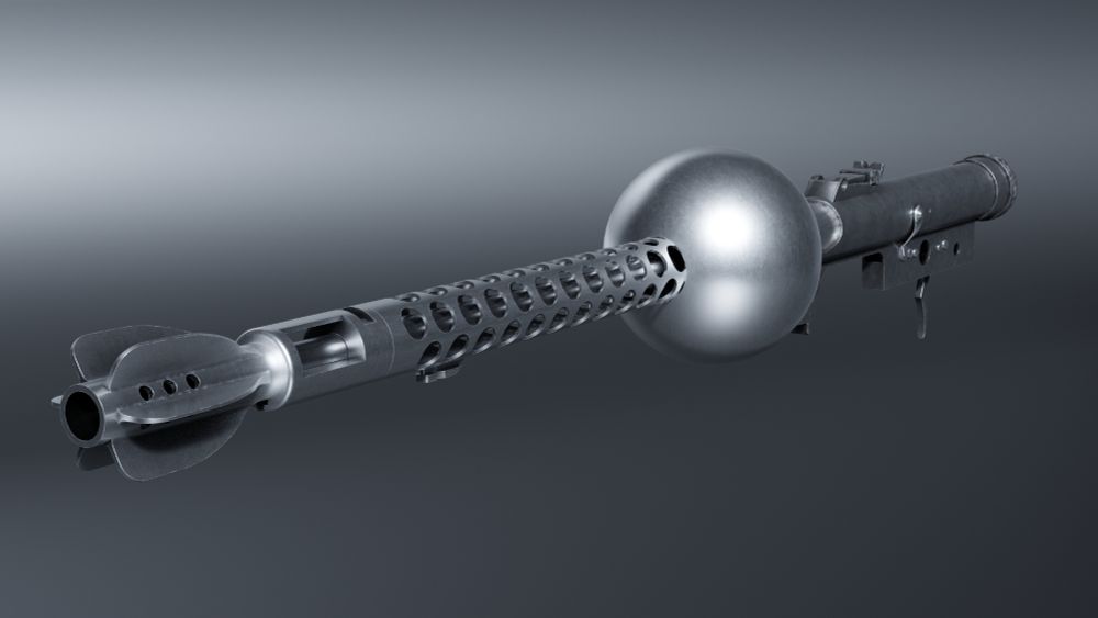 As before, but a perspective angle emphasising the front end of the weapon made from the tail of a 2-inch mortar round grafted onto the compensator (which itself is attached to the barrel and perforated jacket) of a Beretta Model 38A Submachine Gun. There is a groove in the compensator where the forward sight has been removed, and an unused bayonet lug underneath the jacket.
