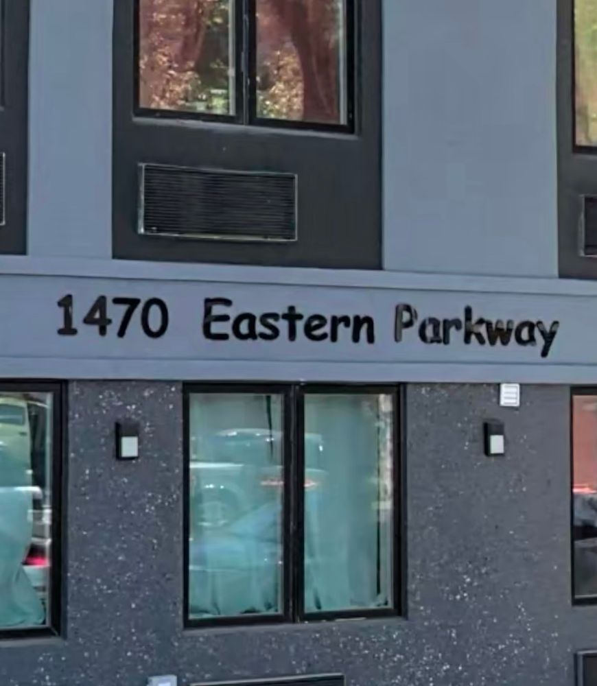A photo of the front of a building with 1470 eastern parkway in comic sans font 