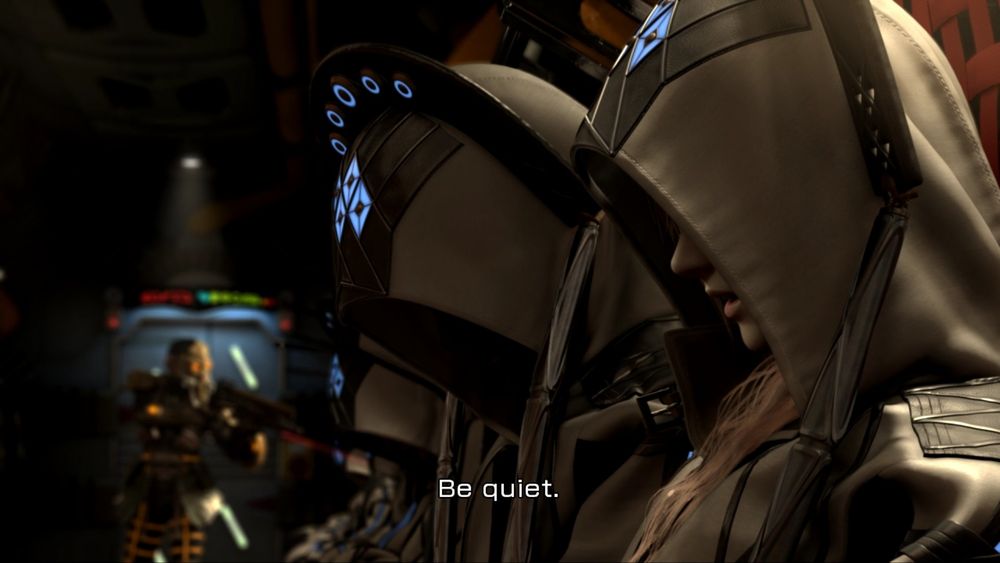 Screenshot from the intro cinematic of Final Fantasy XIII. Inside a dark train car there are several prisoners in white robes adorned with bright blue sigils. An armed guard is inspecting the prisoners in the car. One of the prisoners whispers "Be quiet." to the person sitting next to them.