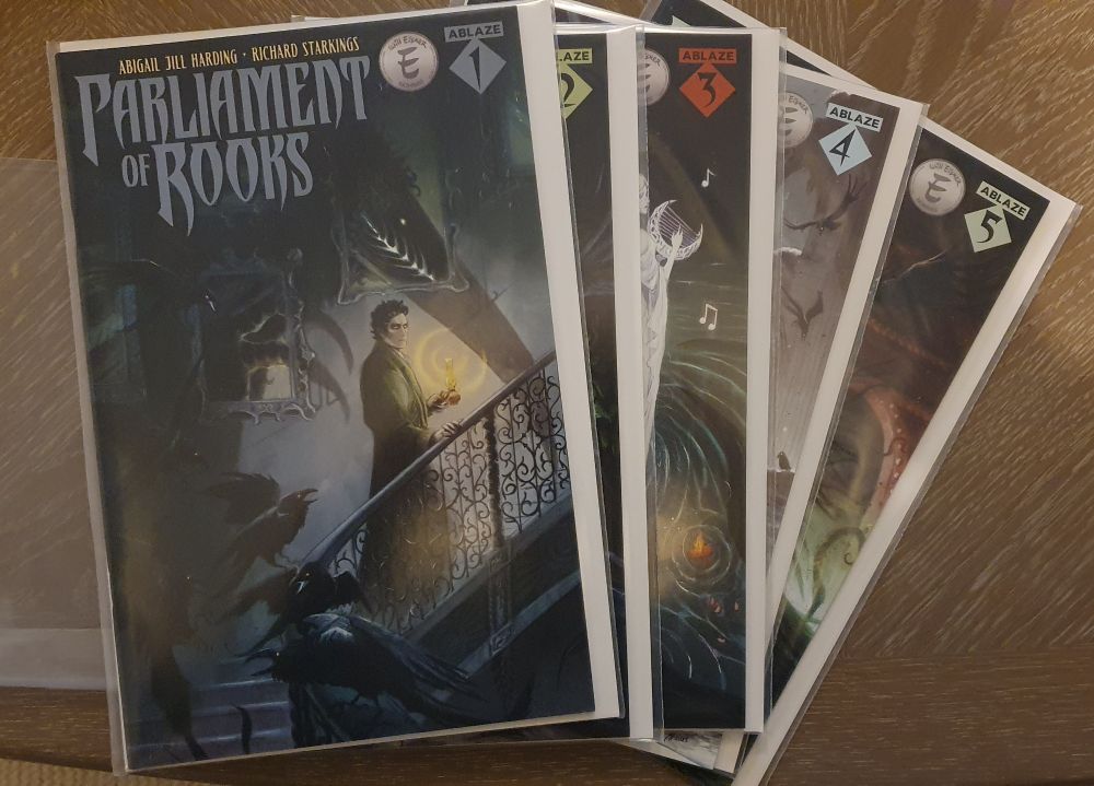 Photo of 5 comics with the title "Parliament of Rooks" visible on the first cover.