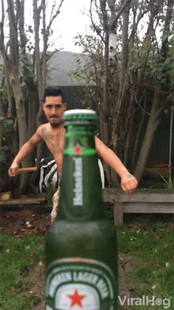 a bottle of heineken beer is being held by a man