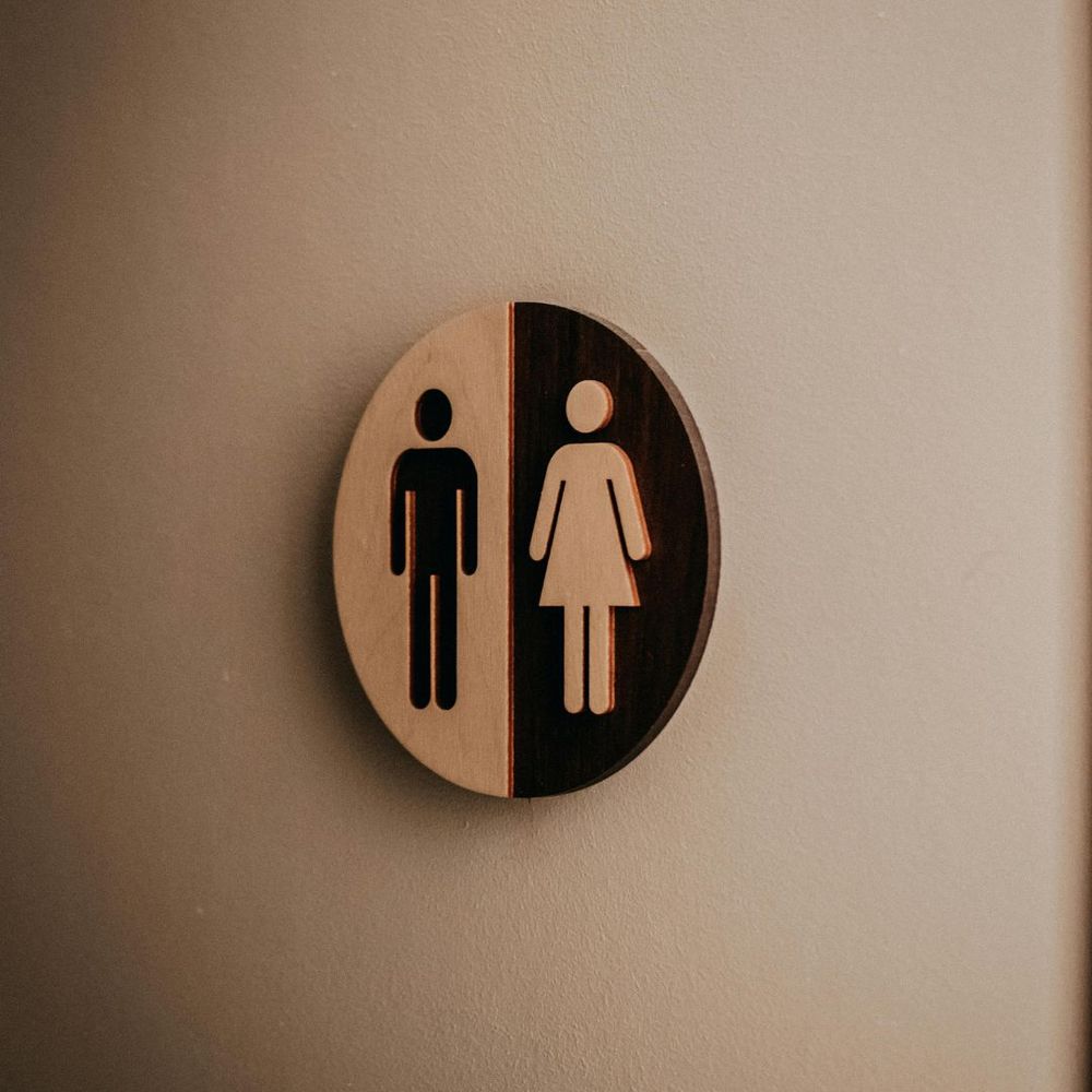 A black and white sign for male and female toilets