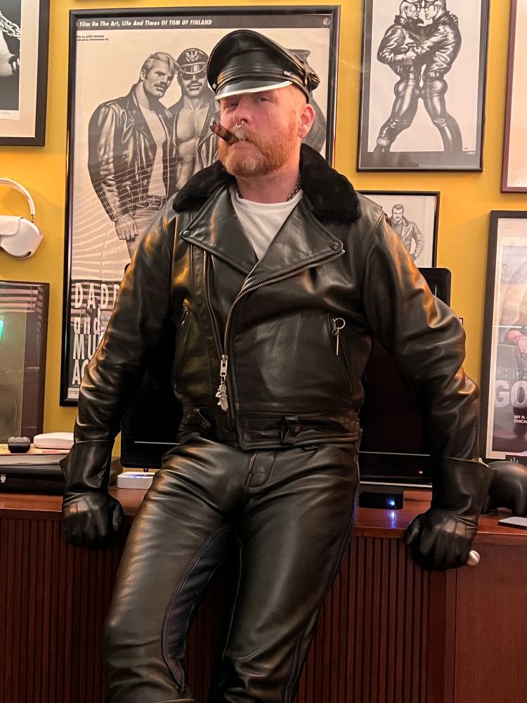 Buford wearing full leathers and smoking a cigar.