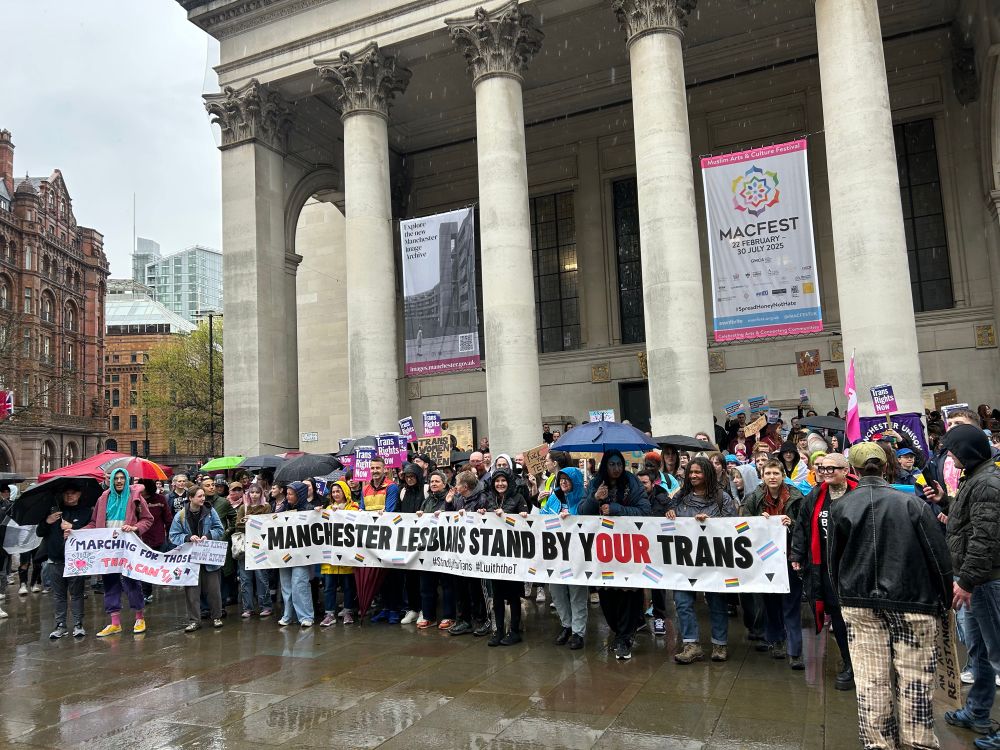 Hundreds join the Manchester trans rights demonstration on 18th April 2025. Banner reads “Manchester Lesbians stand by your Trans”
