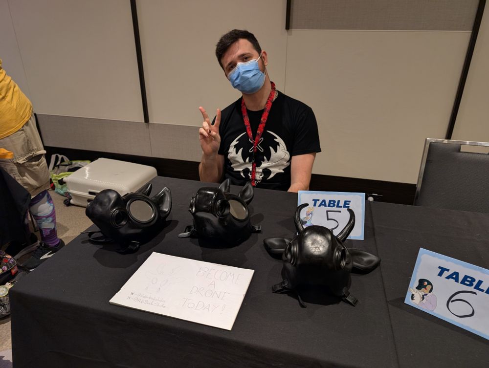 Photo of Rubber Buck Studio's Artist Alley table with the three rubber hoods: Canine, Equine, and Deer.