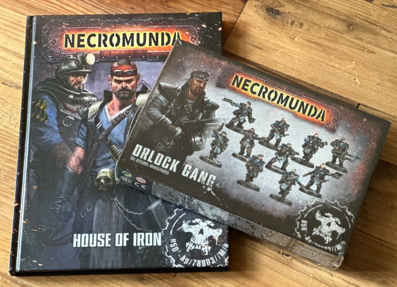 Copy of the Necromunda rulebook House of Iron and an Orlock Gang box