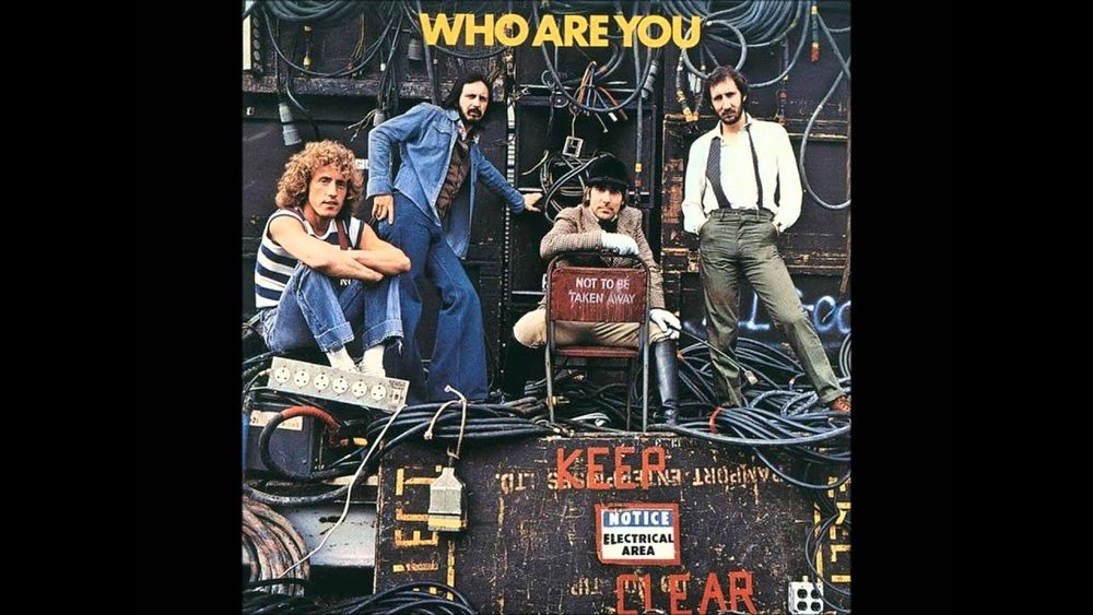 Members of the British band The Who, standing amidst their sound equipment and cables
